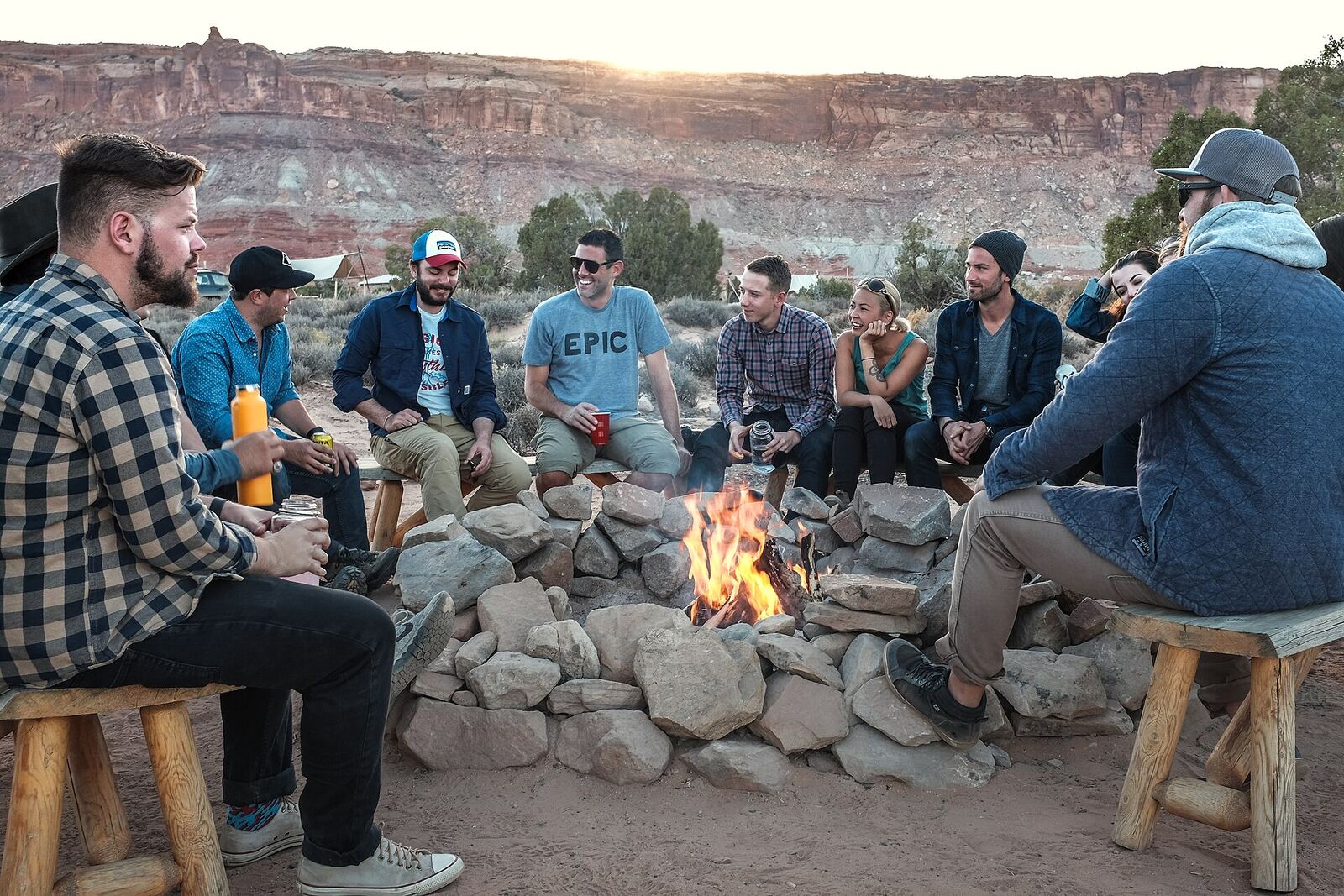 Friends gathered around a fire pit at dusk