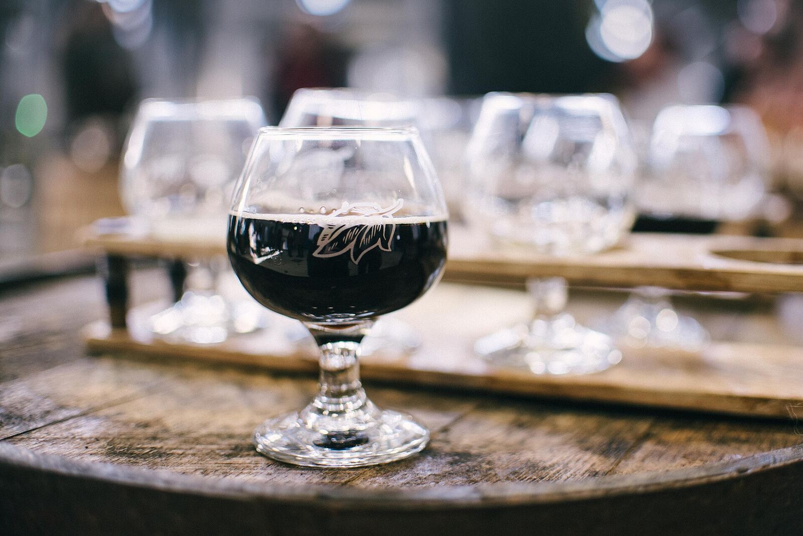 A flight of wines on a wooden tasting-room bar